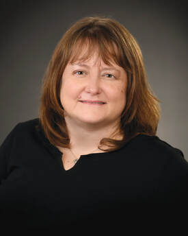 Dr. Lori Hickie smiling while wearing black shirt